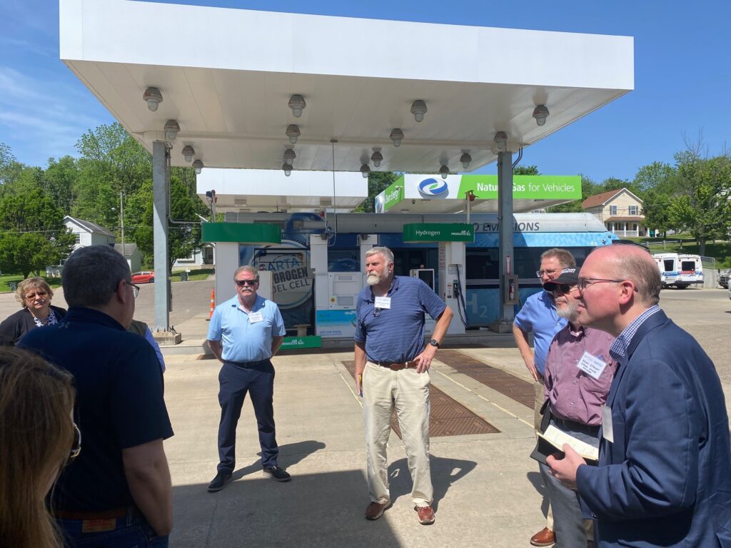 Group with bus and fueling station Group with bus and fueling station